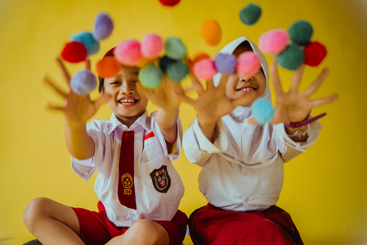 Happy Students Playing with Colorful Balls